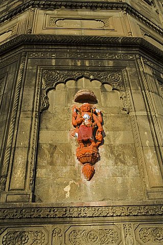 Hindu temple god on wall on banks of the Narmada River, Maheshwar, Madhya Pradesh state, India, Asia