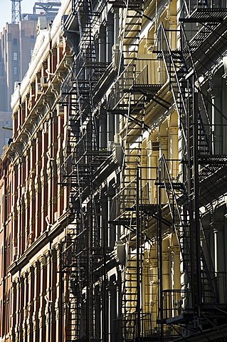 Fire escapes on the outside of buildings in Spring Street, Soho, Manhattan, New York City, New York, United States of America, North America