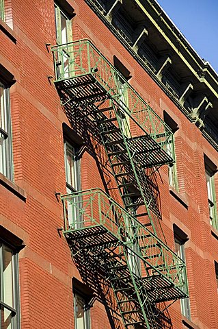 Fire escapes on the outside of buildings in Spring Street, Soho, Manhattan, New York City, New York, United States of America, North America