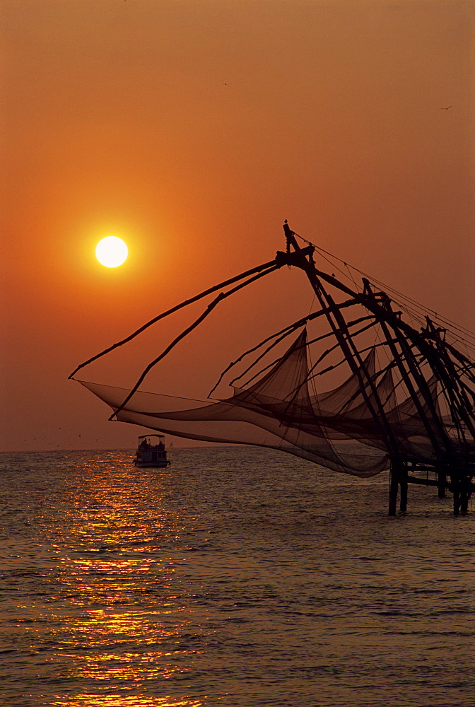 Fishing nets at sunset, Cochin, Kerala state, India, Asia