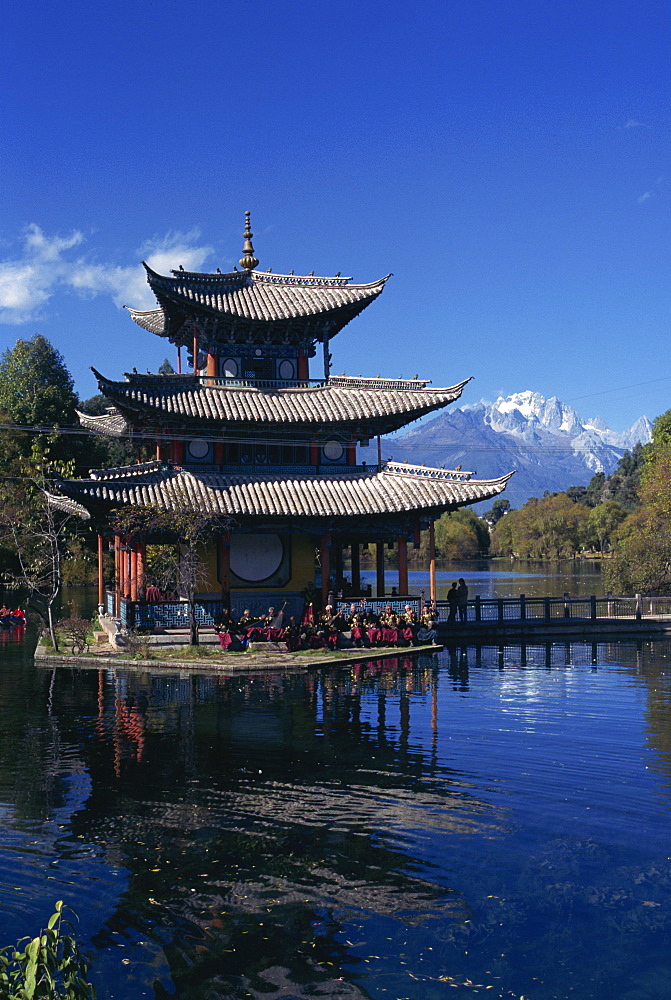 The Naxi orchestra practises beneath a pagoda by the Black Dragon Pool in Lijiang, Yunnan Province, China, Asia