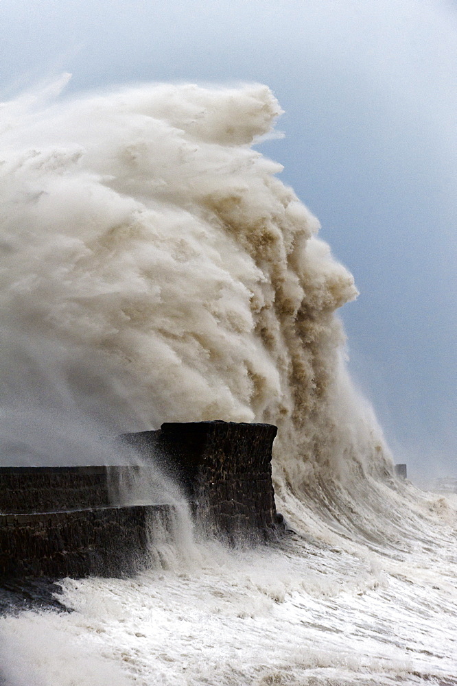 Huge waves crash against the harbour wall at Porthcawl, Bridgend, Wales, United Kingdom, Europe