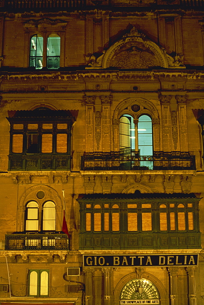 Part of the facade of an ancient palace illuminated night in the city of Valetta, on the island of Malta, Europe