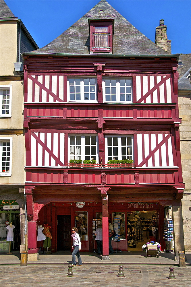 Shops and red half timbered house, Cordeliers Square, Dinan, Brittany, France, Europe