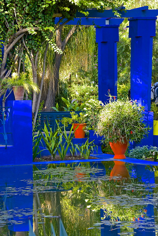 Coloured pots and plants reflected in water basin, in Majorelle Garden, Marrakech, Morocco, North Africa, Africa