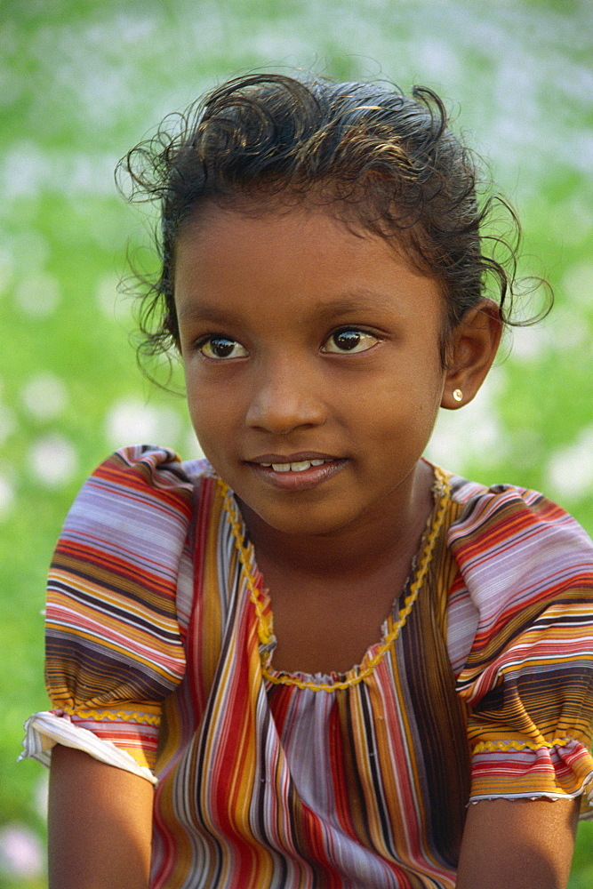 Head and shoulders portrait of a young Sri Lankan girl near Kandy, Sri Lanka, Asia