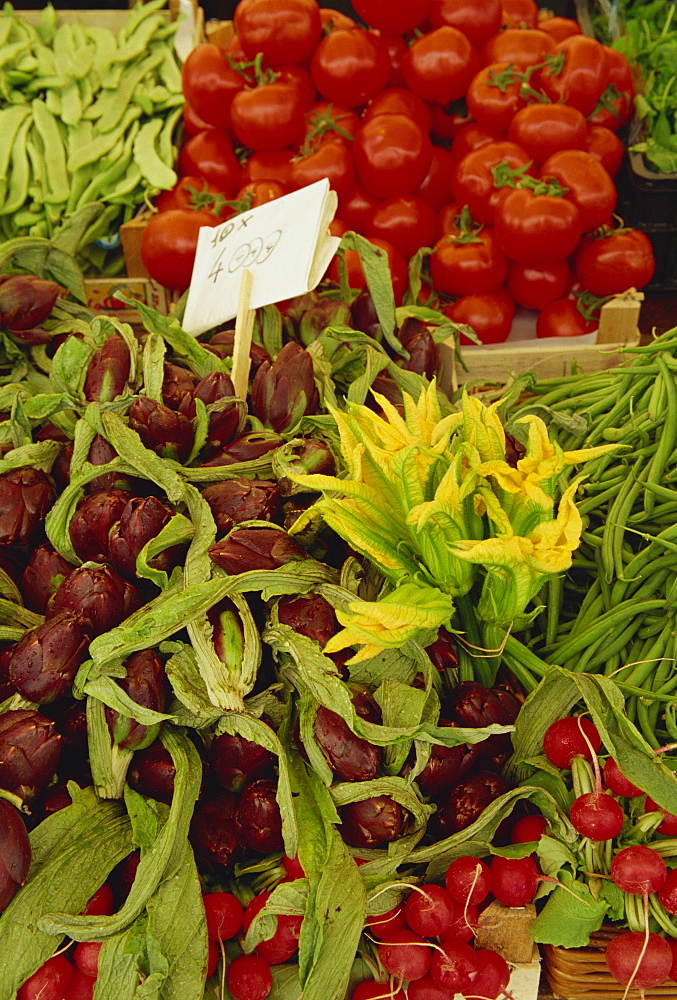 Courgette flowers, artichoke, tomatoes and radishes for sale in the market in Venice, Veneto, Italy, Europe