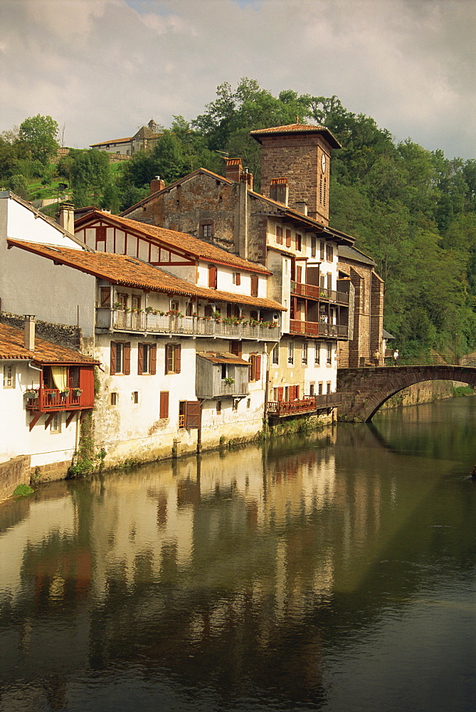 Tranquil scene of houses reflected in water, village of St. Jean Pied de Port in the Pyrenees, Aquitaine, France, Europe