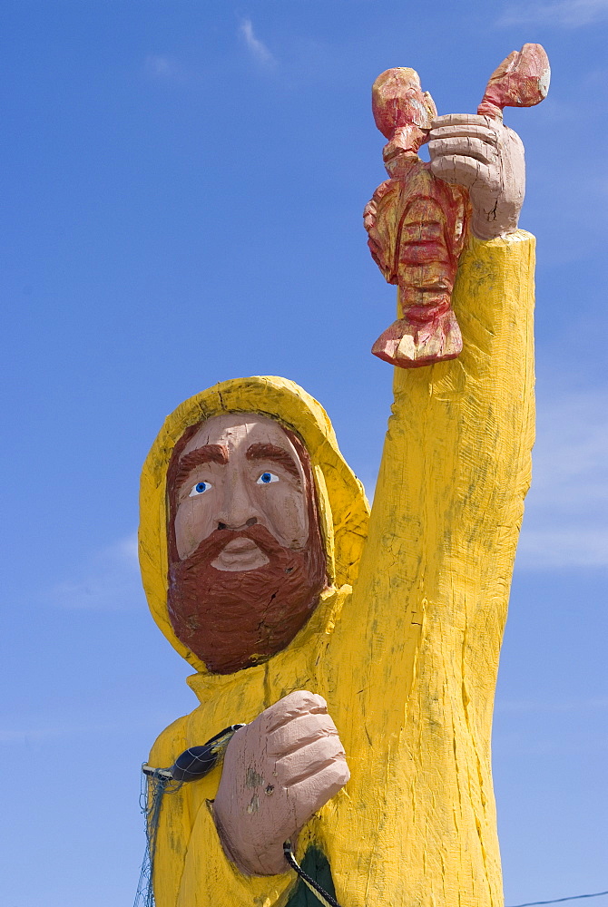 Wood folk-style carving in front of The Rusty Anchor restaurant, Pleasant Bay, Cape Breton, Nova Scotia, Canada, North America