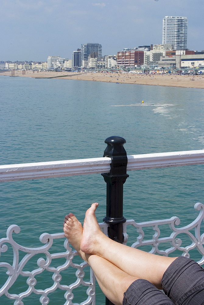 Foot sunbathing on the pier, Brighton, Sussex, England, United Kingdom, Europe