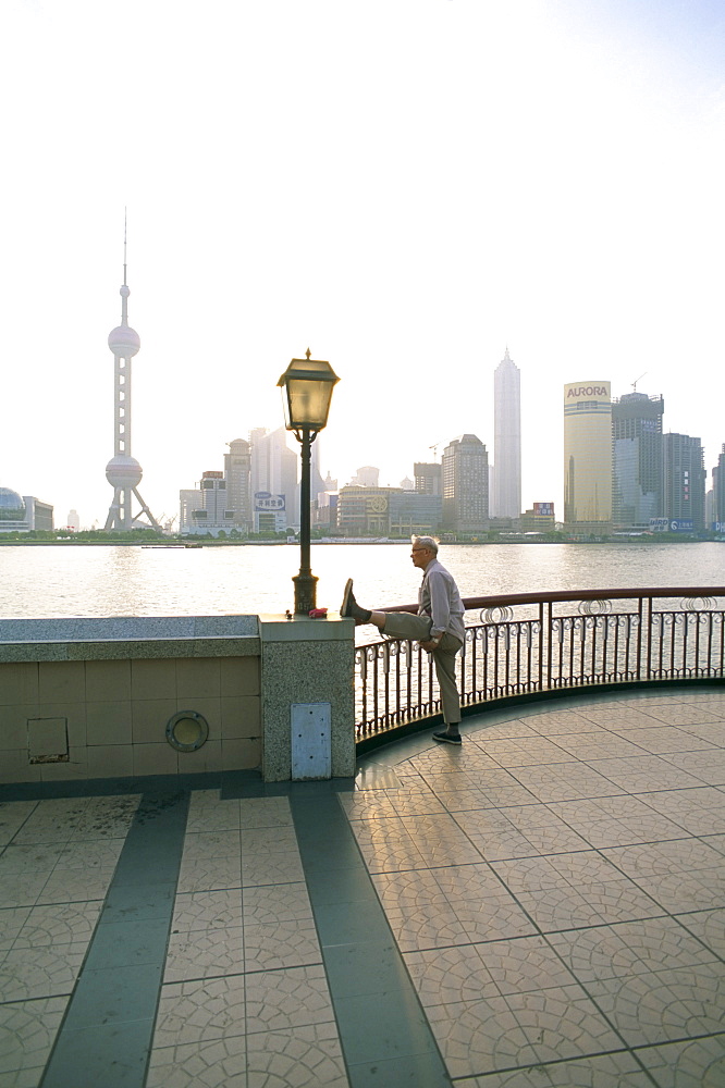 Senior man stretching leg, Shanghai, China, Asia