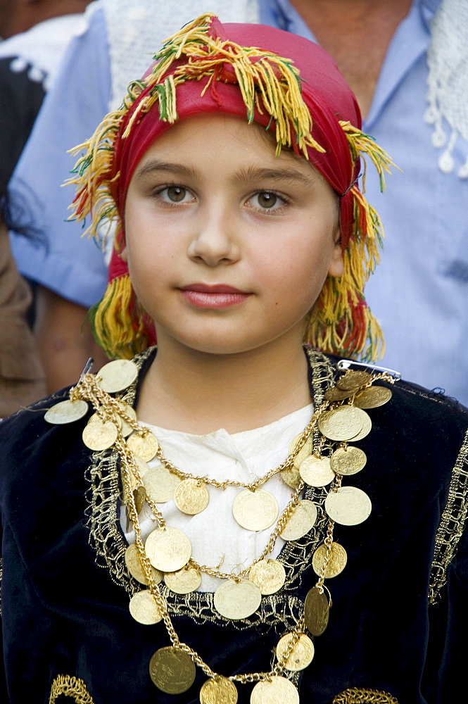 Young girl attending village wedding, Anogia, Crete, Greek Islands, Greece, Europe