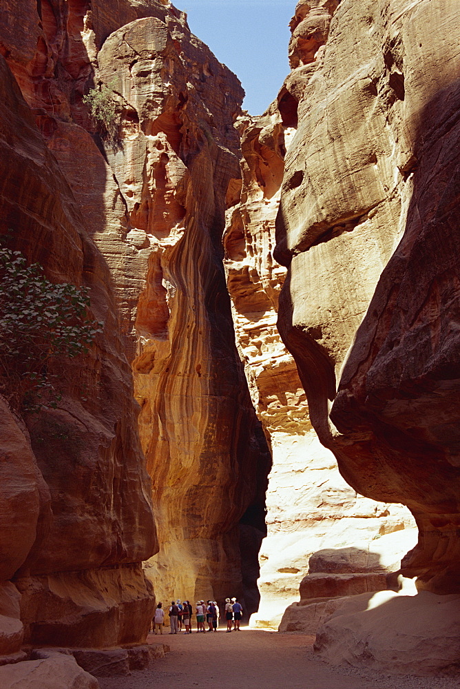 The Siq, narrow entrance between rock cliffs, to the site of Petra, UNESCO World Heritage Site, Jordan, Middle East