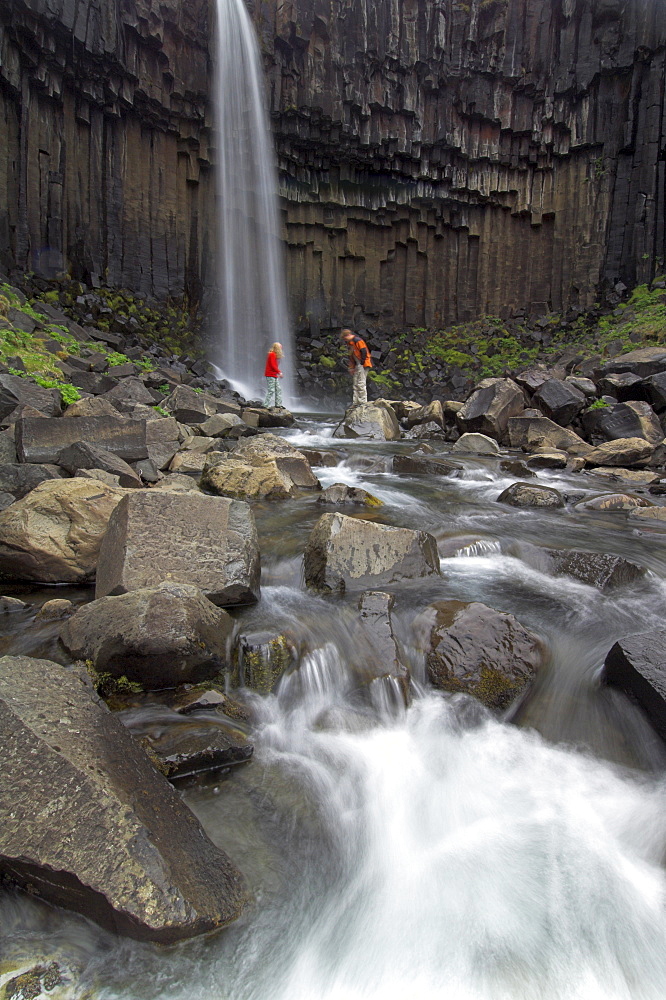 Tourists at Svartifoss waterfall, with basalt columns, Skaftafell National Park, South area, Iceland, Polar Regions