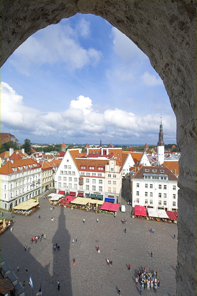 Tourists in the Old Town square with cafe canopies, Tallinn, Estonia, Baltic States, Europe