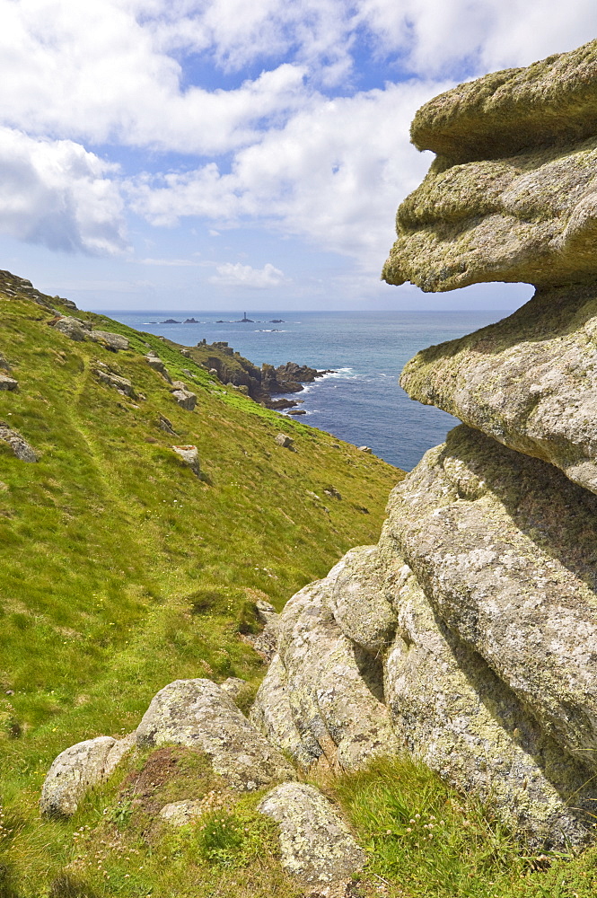 Part of the South West Coast Path at Mayon cliff near Land's End showing the Longships lighthouse in the distance, Cornwall, England, United Kingdom, Europe