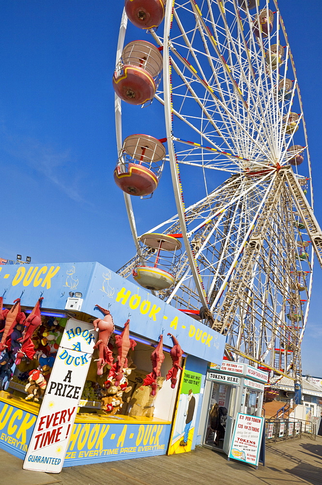 Big wheel and prize stall on the Central Pier, Blackpool, Lancashire, England, United Kingdom, Europe