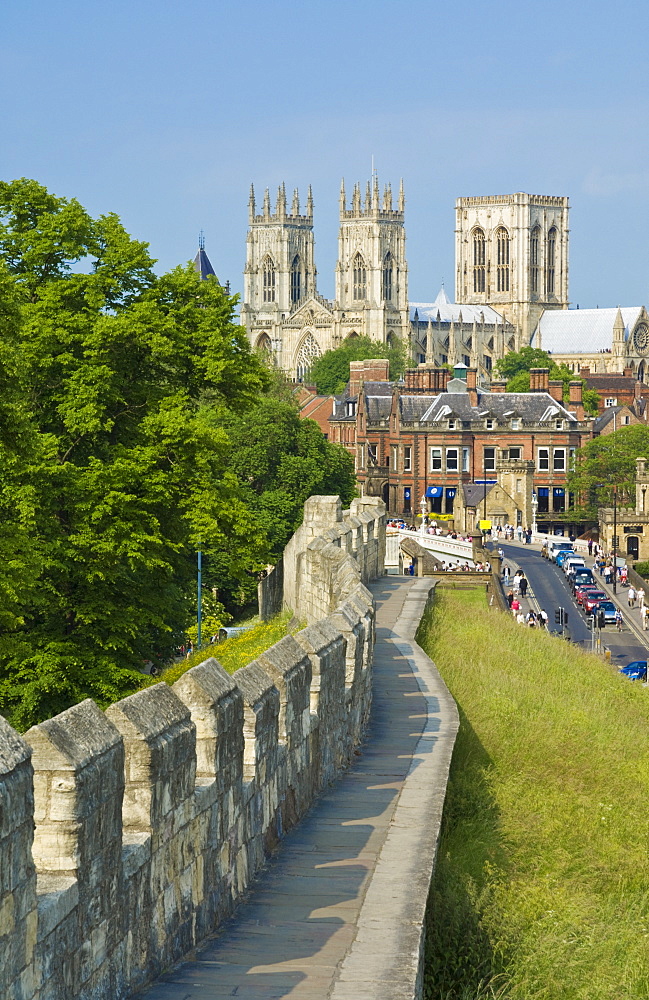 York Minster, northern Europe's largest Gothic cathedral, and a section of the historic city walls along Station Road, York, Yorkshire, England, United Kingdom, Europe