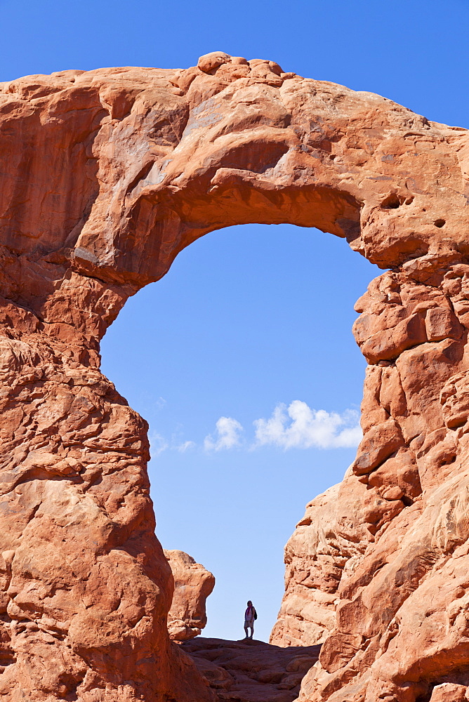 Lone hiker in Turret Arch, Arches National Park, near Moab, Utah, United States of America, North America 