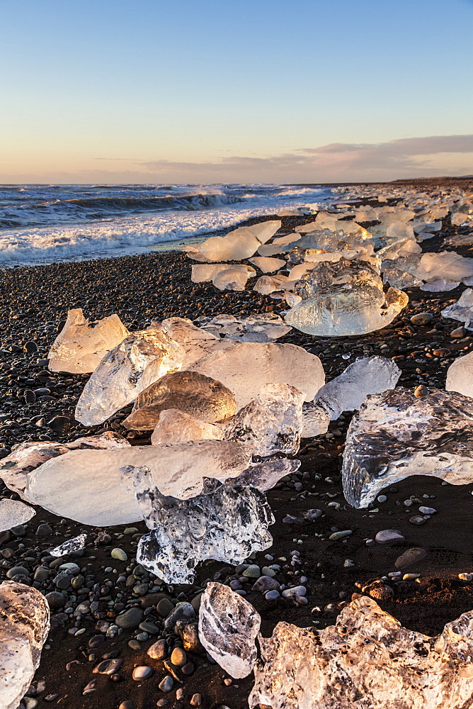 Broken ice from washed upiIcebergs on Jokulsarlon black beach at sunrise, Jokulsarlon, south east Iceland, Iceland, Polar Regions