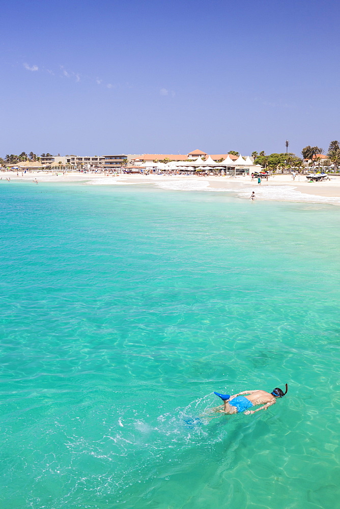 Boy snorkelling off the sandy beach in Santa Maria, Praia de Santa Maria, Baia de Santa Maria, Sal Island, Cape Verde, Atlantic, Africa