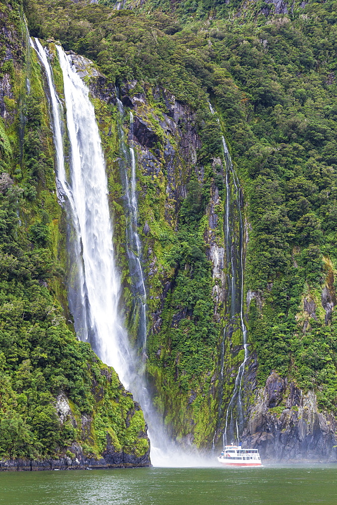 Stirling Falls waterfall and tourist boat, Fiordland National Park, UNESCO World Heritage Site, Milford Sound, New Zealand, Pacific