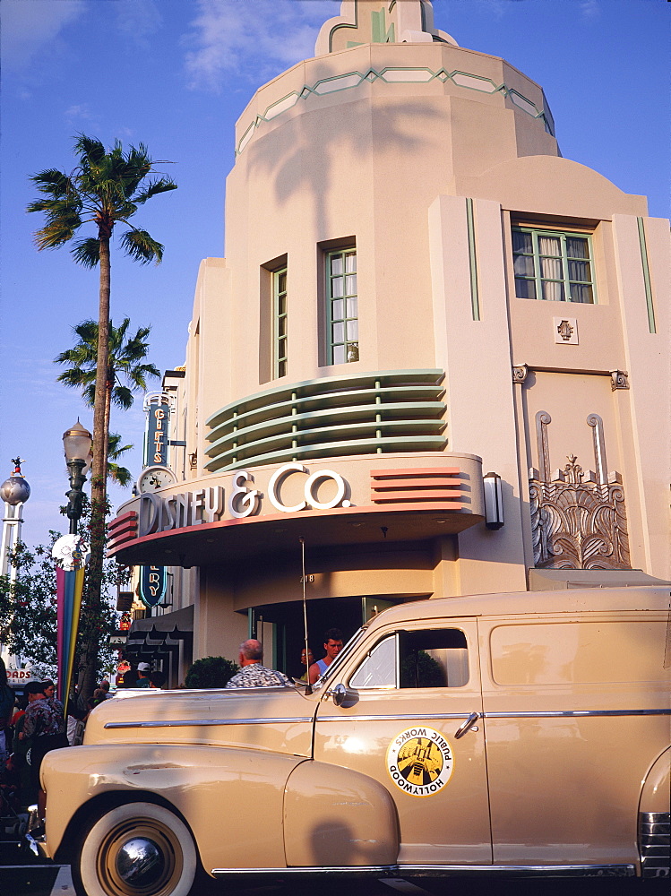 Classic car outside art deco Disney building, Main Street, MGM Park, Orlando, Florida, USA