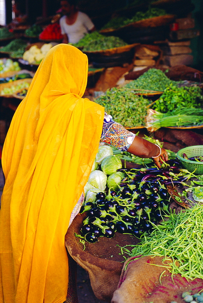 Woman shopping for vegetables at a  market in Jodphur, Rajasthan, India 