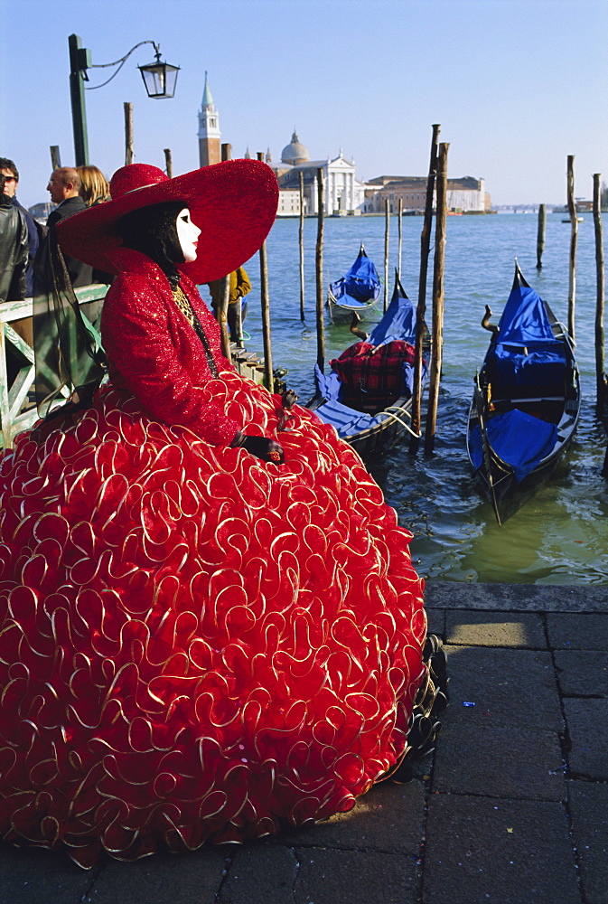 Person wearing masked carnival costume, San Giorgio in the background, Venice Carnival, Venice, Veneto, Italy