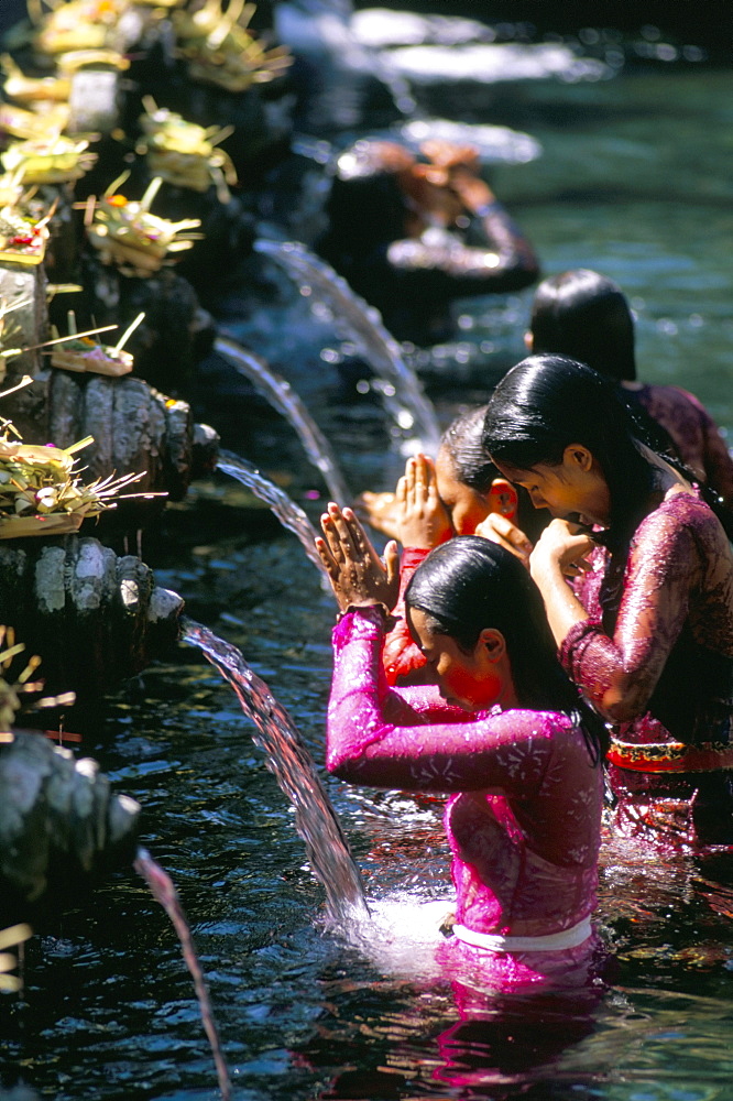 Young women at Tirta Empul temple, Ubud region, island of Bali, Indonesia, Southeast Asia, Asia