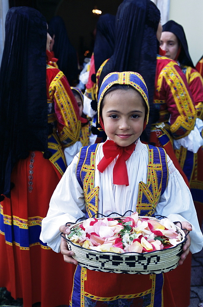 Girl carrying rose petals, Corpus Domini procession, Desulo (Gennargentu), Sardinia, Italy, Europe