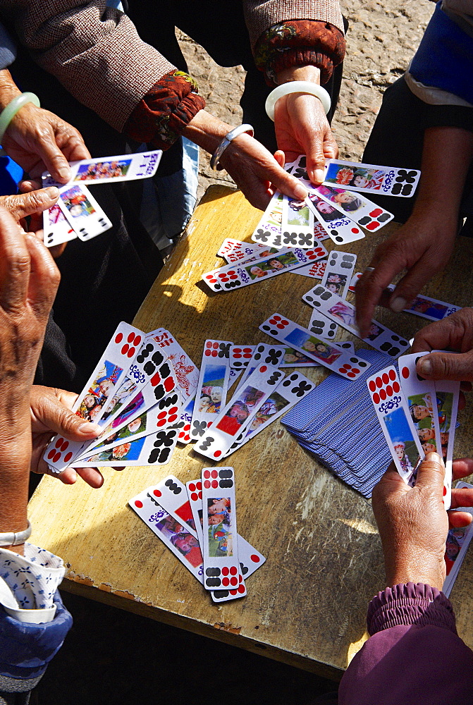 Naxi women playing a local game of cards, Lijiang, Yunnan, China, Asia 