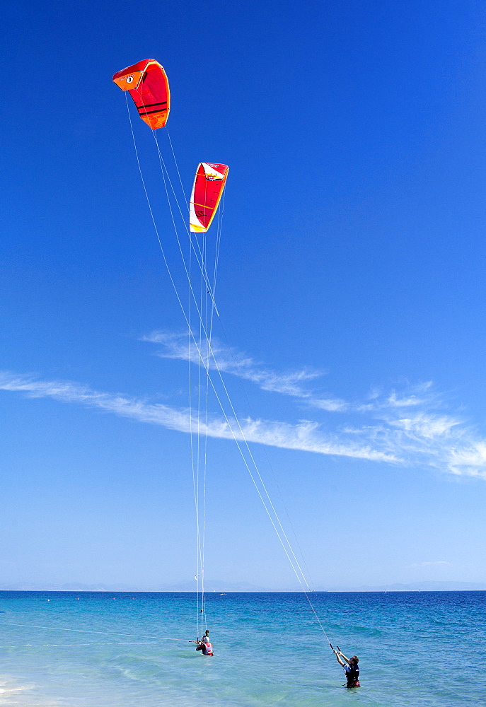 Two kiteboarders trying to take off, Tarifa, Costa de la Luz, Cadiz Province, Andalucia (Andalusia), Spain. Europe