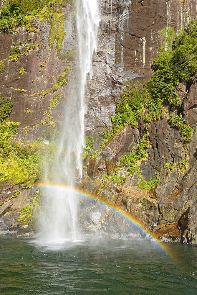 Rainbow over waterfall, Milford Sound, Fiordland National Park, UNESCO World Heritage Site, Southland, South Island, New Zealand, Pacific