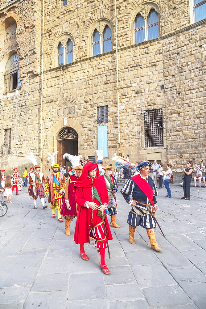 Men marching in costume during Calcio Storico Fiorentino festival at Piazza della Signoria in Florence, Tuscany, Italy, Europe