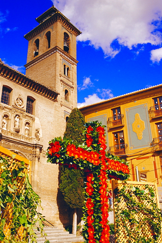 Dia de la Cruz, floral cross with Santa Ana church in the background, Plaza Nova, Granada, Andalucia, Spain 