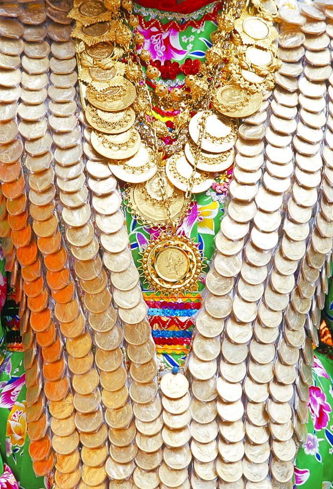 Close-up of a girl's dress decorated with old gold coins, Lambri Triti festival, Olymbos, Karpathos, Dodecanese islands, Greece, Mediterranean, Europe