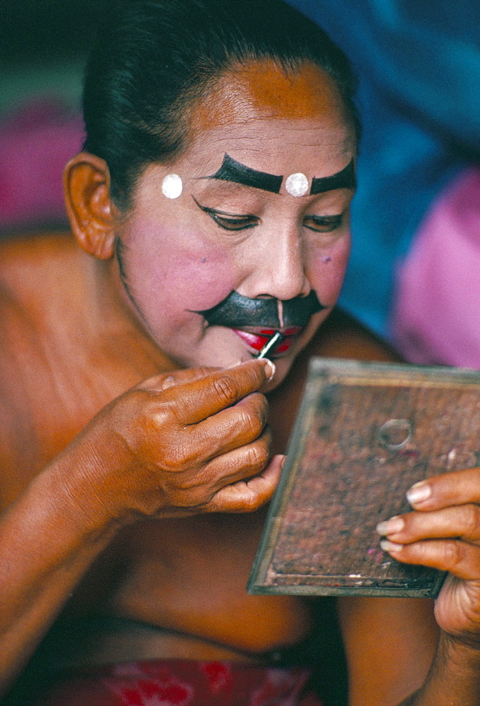 Applying make-up for the Barong classical dance, temple of Batubulan, island of Bali, Indonesia, Southeast Asia, Asia