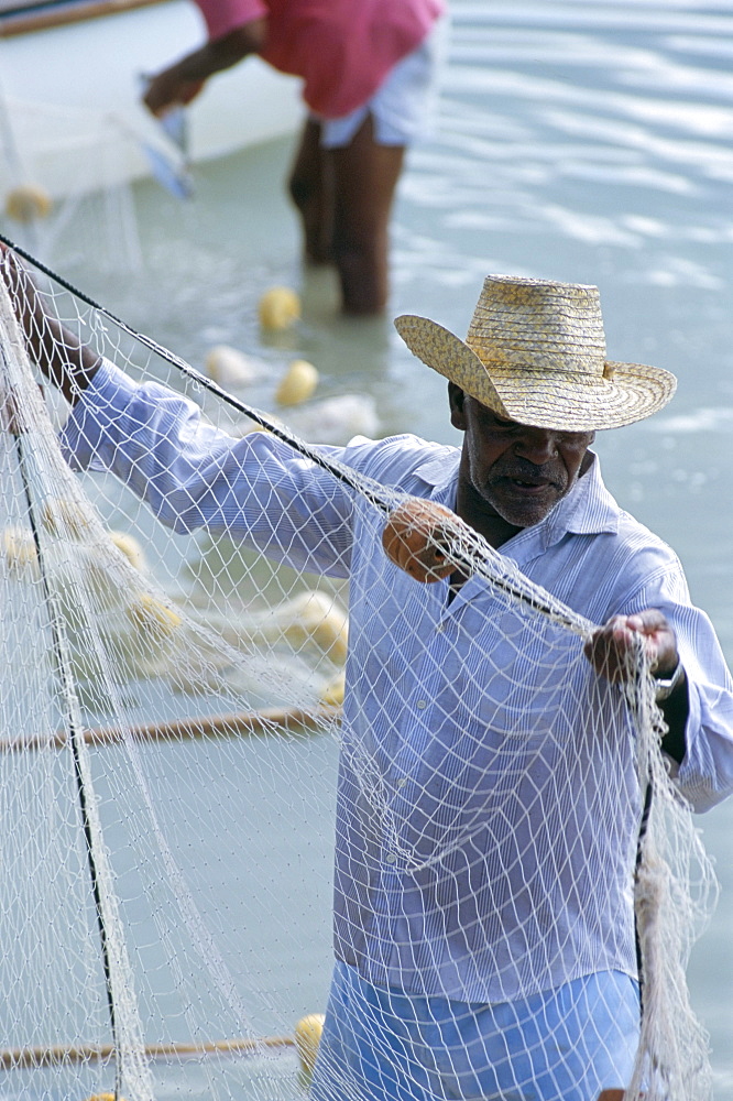 Fisherman and net, Anse Sainte Anne, island of Praslin, Seychelles, Indian Ocean, Africa