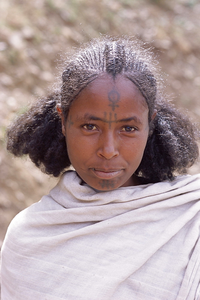 Head and shoulders portrait of a young Gourage woman with facial tattoo, Lasta Valley, Wollo region, Ethiopia, Africa