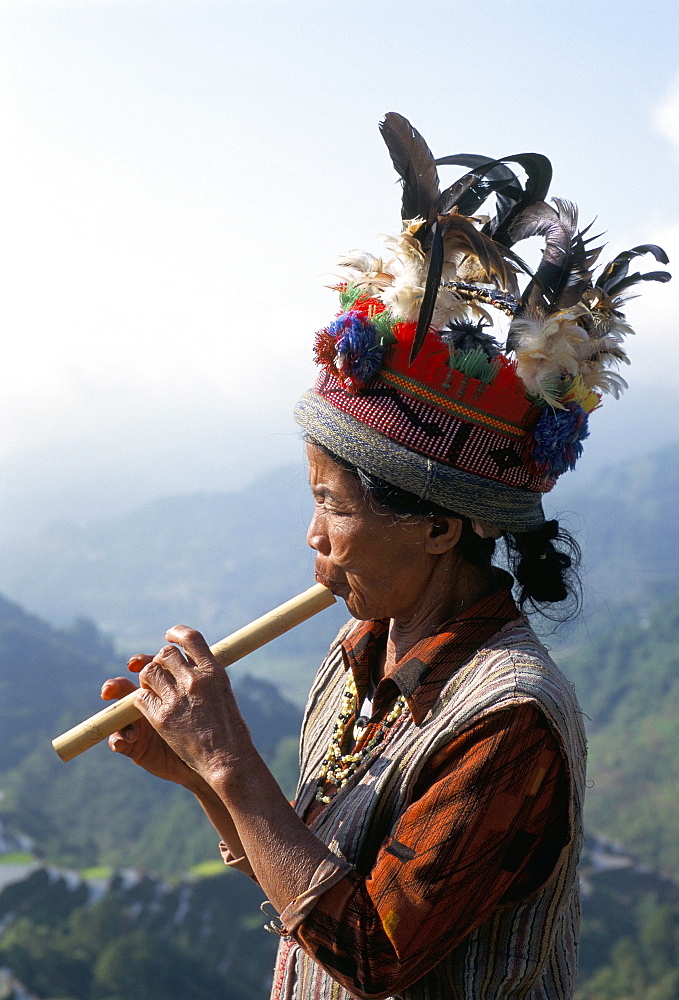 Ifugao person playing a pipe, northern area, island of Luzon, Philippines, Southeast Asia, Asia