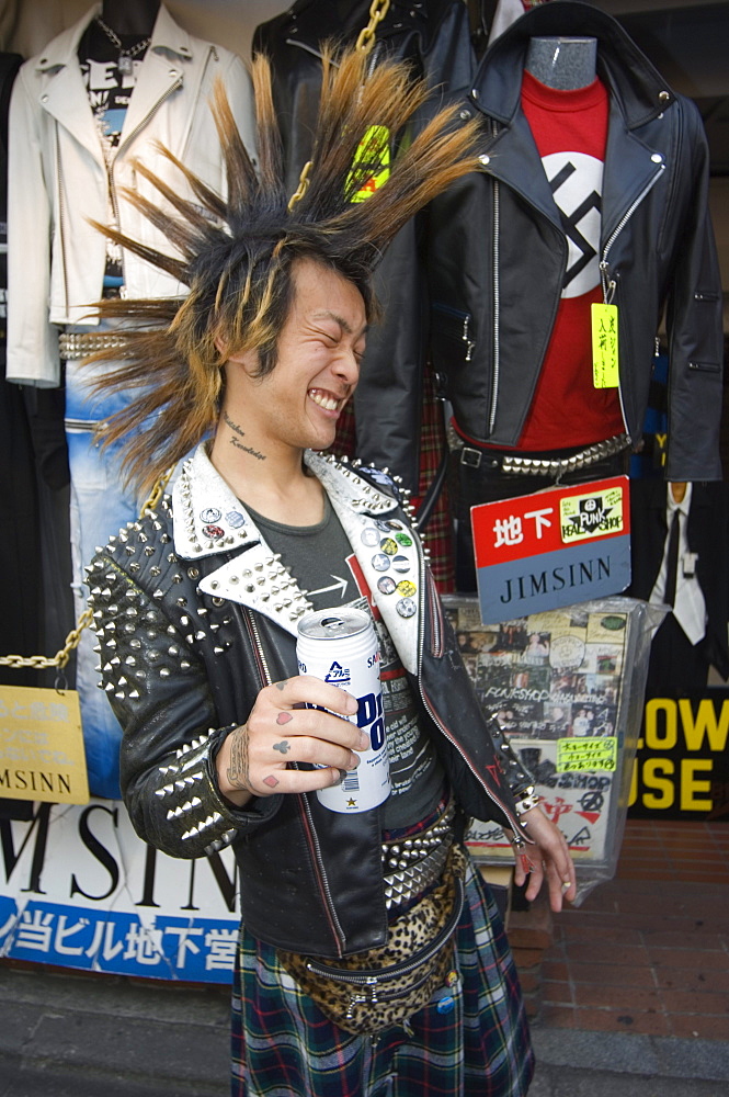 Boy with spiky hair and tartan kilt, drinking beer, Tokyo, Japan, Asia