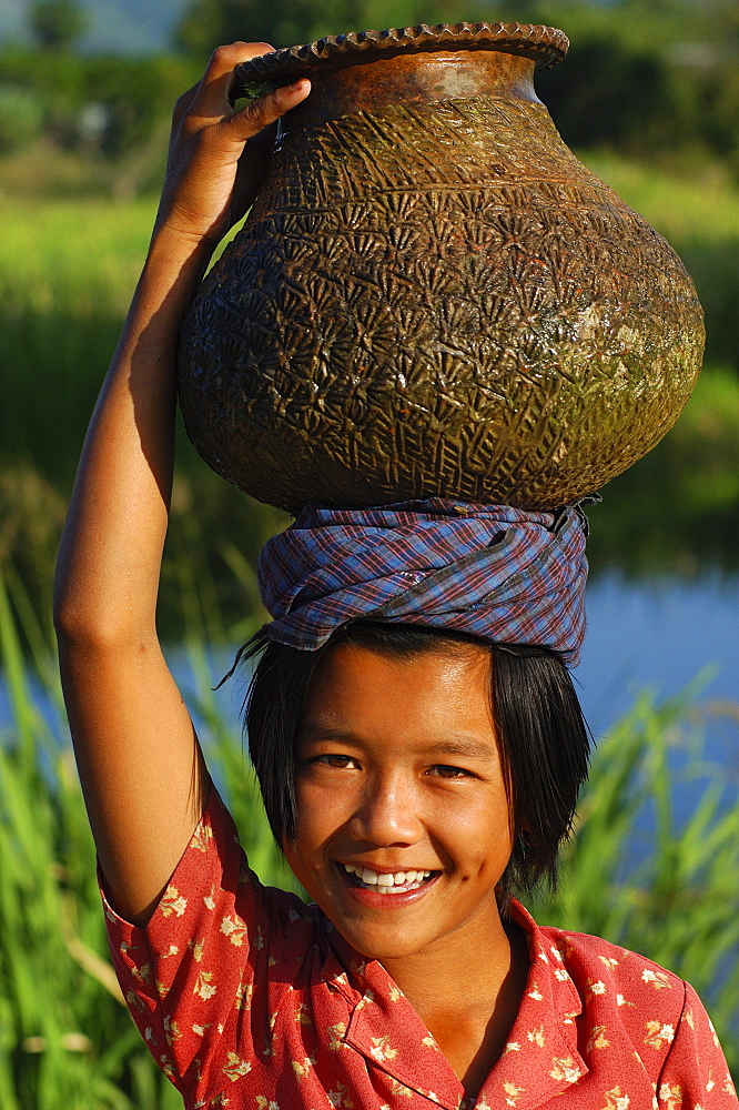 Young girl with water jar on head, Inle Lake, Shan State, Myanmar (Burma), Asia