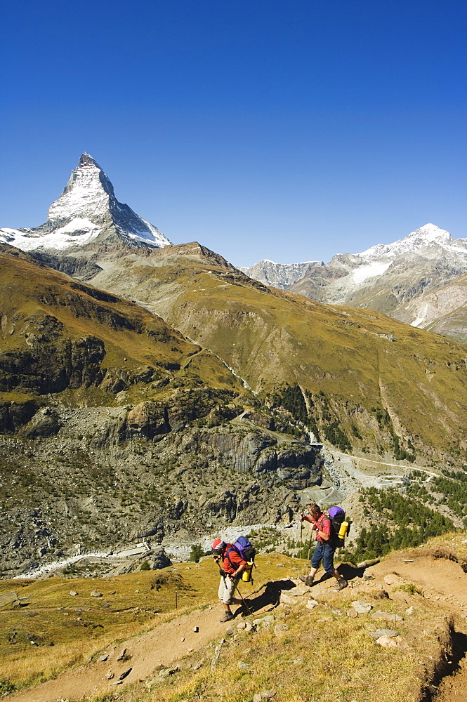 Hikers walking on trail near the Matterhorn, 4477m, Zermatt Alpine Resort, Valais, Switzerland, Europe 