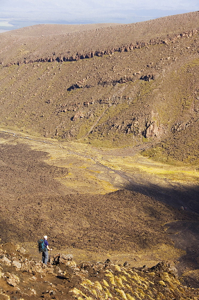 Hikers walking through a lava field on the Tongariro Crossing, Tongariro National Park, the oldest national park in the country, UNESCO World Heritage Site, Taupo Volcanic Zone, North Island, New Zealand, Pacific