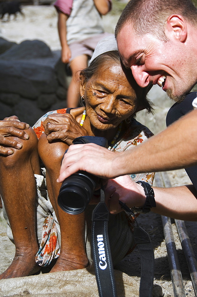 Local elderly Igorot woman and western tourist with camera, Tulgao Village, near Tinglayan Town, The Cordillera Mountains, Kalinga Province, Luzon, Philippines, Southeast Asia, Asia