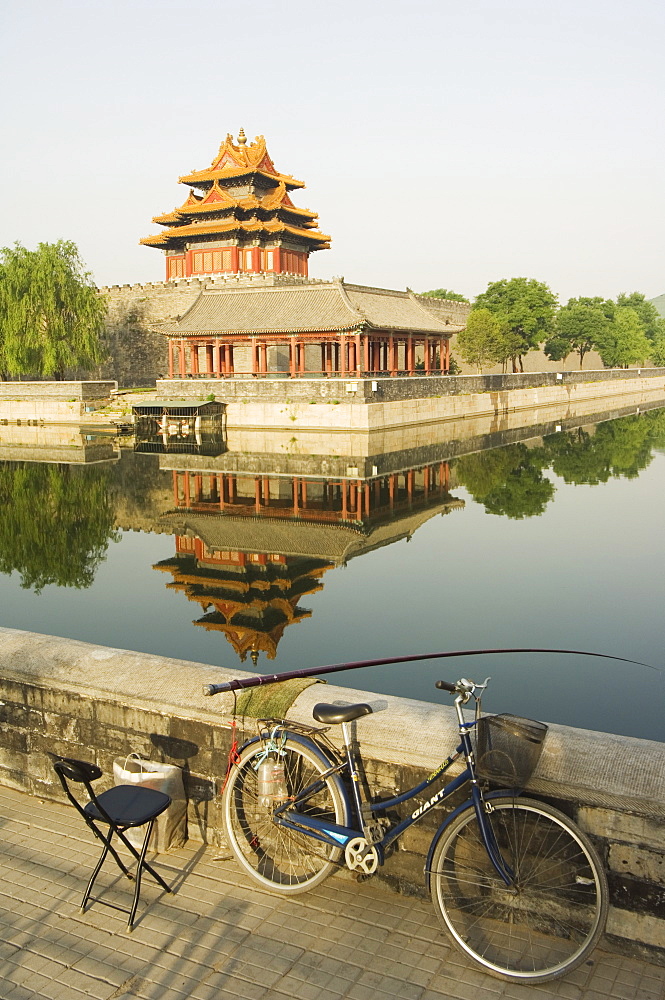 Fishing in the moat with a reflection of the Palace Wall Tower of The Forbidden City Palace Museum, UNESCO World Heritage Site, Beijing, China, Asia