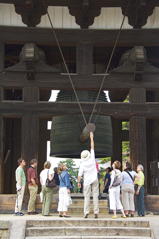 Tourists look at big cast iron bell, Todaiji (Big Buddha) Temple, constructed in the 8th century Nara City, Nara Prefecture, Honshu Island, Japan, Asia 