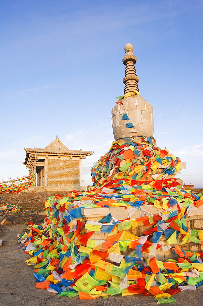 Sunrise on a monastery stupa and prayer flags on Yedou Peak, 3058m, at Wutaishan (Five Terrace Mountain) one of China's sacred Buddhist mountain ranges, Shanxi province, China, Asia