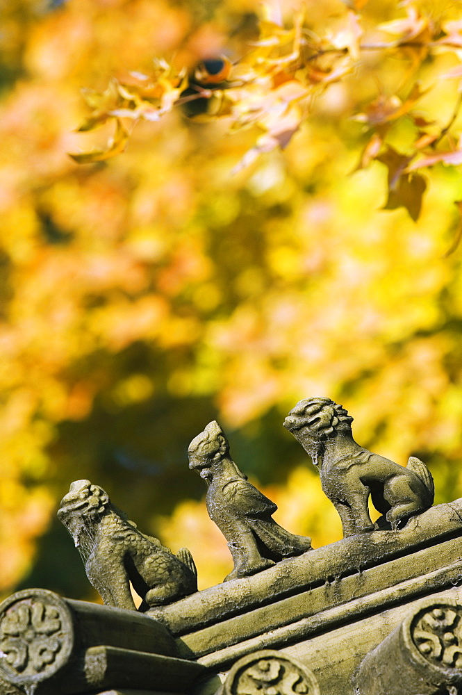 Autumn colours and ornamental Chinese style decorative figures on a pavilion in Ritan Park, Beijing, China, Asia